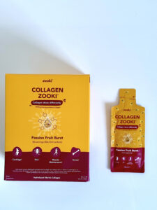 Image of Zooki Collagen packaging box and a pouch next to it. This collagen is passion fruit flavour and demonstrates the daily portion of liquid that is suggested to consume.